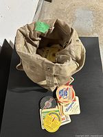 Canvas shoulder bag with coasters spilling out