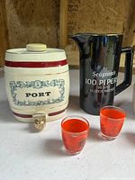 Port barrel, Seagram's pitcher, two red shot glasses visible