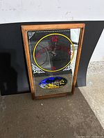 Front view showing mirrored clock face, logo and scene