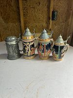 Group shot of four steins on table