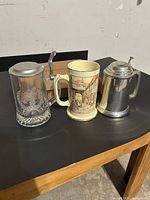 Three beer mugs on table