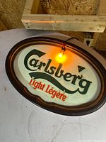 Front view of Carlsberg Light Légère illuminated beer sign showing logo, text, frame and added bulb