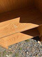 Top shelf surface showing laminate finish and scratch