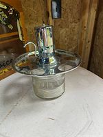 glass cocktail decanter showing glass base and chrome top