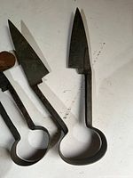 Two sheep shears showing blades and loop handles