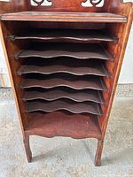 Front view showing open shelves and cabinet structure