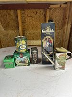 All six tins grouped on table