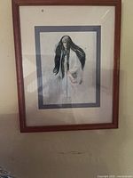 Wood-framed print of long-haired woman