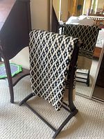 Blanket rack with woven blanket draped, partial desk visible