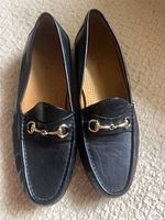 Top view of both loafers showing horsebit hardware and leather uppers