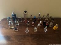 Group shot of all miniature perfume bottles on wooden surface