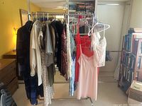Overall view of garment rack with clothing, ties and hangers