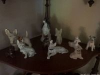 Group of ceramic dog figurines on shelf