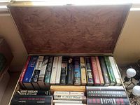 Open chest showing interior finish and assortment of hardcover books