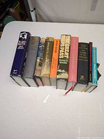 Full group of ten hardcover military books on table