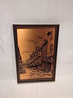 Front view of one copper etched picture showing street scene