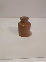 Full view of stoneware bottle on white background