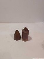 Both stoneware bottles side by side on plain background