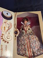 Box opened showing Queen Elizabeth I Barbie doll in display