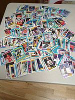 Wide view of large spread of hockey cards on table