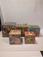 Front view of five nesting blocks showing various illustrations