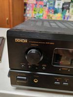 Front left showing Denon logo, source knob, headphone jack