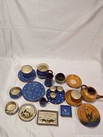 Overall group of pottery pieces laid out on cloth