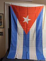 Full view of Cuban flag hanging to show design and size