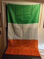 Full view of Ireland flag hanging to show entire design and condition