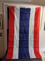 Full view of Thailand flag hanging, showing color pattern and grommets