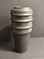 Full view of ceramic vase front with ringed upper portion