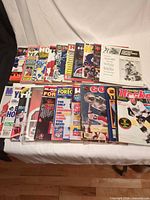 Two rows of assorted hockey magazines and annual guides