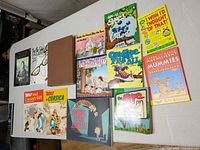 All books laid out on table showing covers