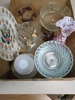 Box containing assorted glassware, porcelain teacup, ruffled vase, pitcher and collector plate
