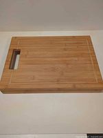 Top view of bamboo cutting board showing juice groove and handle opening
