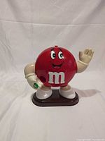 Front view of red M&M candy dispenser