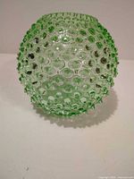 Front view of green glass hobnail vase/bowl