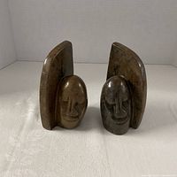 Front view showing carved faces and overall form