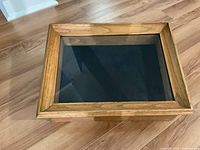 Top view of wood display cabinet showing glass lid