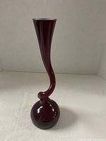 Full front view of burgundy twisted stem vase showing shape and color