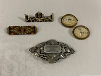 Front view of all five brooches