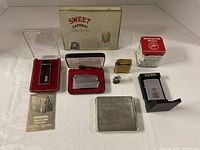 Overall view of all lighters, cigarette case, tins and accessories