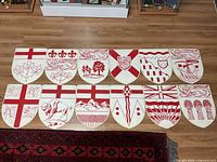 All twelve shield plaques laid out two rows of six
