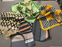 Group shot of the four silk scarves showing colors and patterns