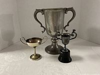 Front view of three trophies showing materials and sizes