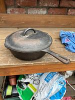 Pan with lid on wooden surface