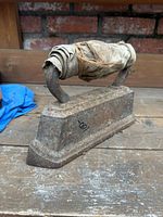 Full view of the cast iron sad iron on wooden surface