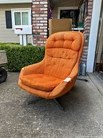 Front three-quarter view of orange swivel lounge chair