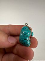 Front view of turquoise pendant showing stone color, matrix and bail
