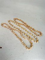 Three seashell necklaces laid out